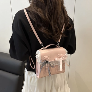 Pink ballet-style mini backpack for women with lace trim and decorative bows