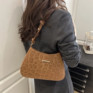 Brown leopard print suede shoulder bag with gold metal trim and knotted strap detail