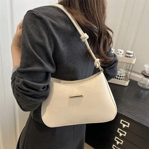 Minimalist beige PU leather underarm bag with gold hardware and knotted strap detail