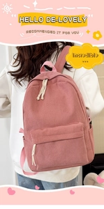 Pink corduroy backpack shown on model with front zipper pocket and side pouches