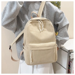 Detail of beige corduroy backpack with woven rope zipper pulls on a female model