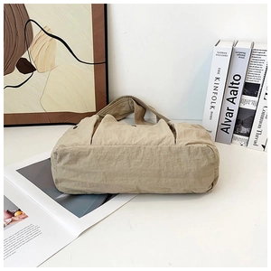 Macro view of khaki nylon tote bag showing side structure and large storage capacity