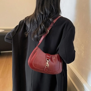 Burgundy crescent moon underarm bag in glossy patent leather with silver buckle