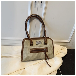 Close-up of vintage army green textured fabric and dark brown leather shoulder bag detail