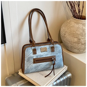 Detail of vintage tote bag with marble texture fabric and dark brown leather straps