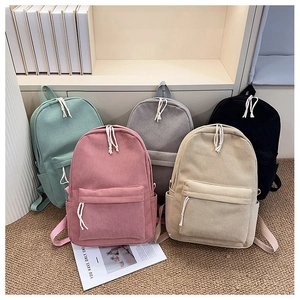 Detailed collection of striped corduroy backpacks in five colors with woven zipper pulls