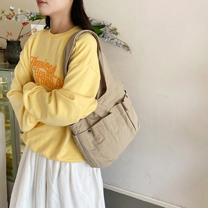 Khaki large capacity nylon tote bag with multiple pockets and shoulder straps for women