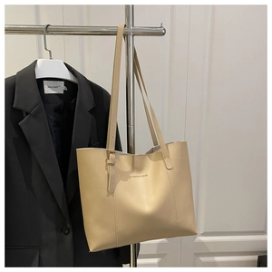 Detail of light beige leather tote bag with Fashion & Bags text on minimalist background