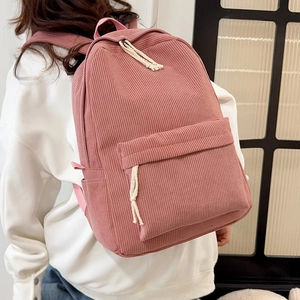Pink corduroy minimalist backpack for women with front zipper pocket and adjustable straps