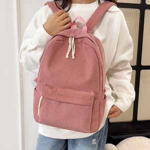 Pink corduroy backpack for women with white rope zippers and soft striped texture