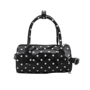 Chic black polka dot cylinder handbag in shiny patent leather with double handles