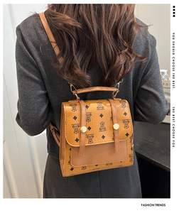 Detail of vintage brown mini backpack with bear print and flip-top magnetic buckle
