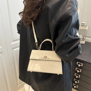 Creamy white trapezoidal leopard print handbag with gold buckle and leather strap
