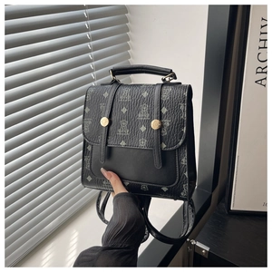Mini black pebbled leather backpack with bear print and golden button details