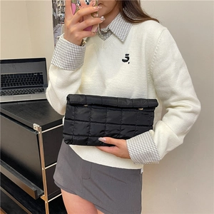 Quilted black clutch bag in lightweight padded fabric for a chic minimalist look