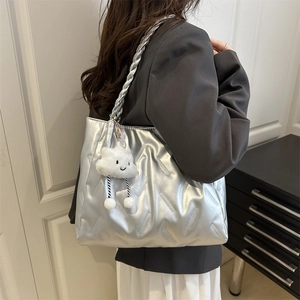 Silver metallic quilted tote bag with woven shoulder strap and plush cloud charm