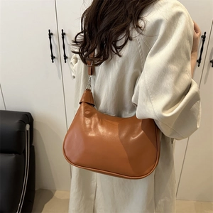 Vintage brown leather underarm bag for women with half-moon shape and shoulder strap
