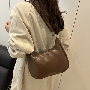 Retro dark brown leather underarm bag with minimalist design for stylish women
