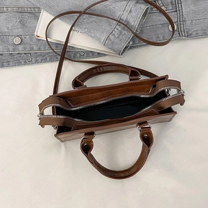 Top view of vintage brown leather pillow bag showing spacious interior and dual zipper