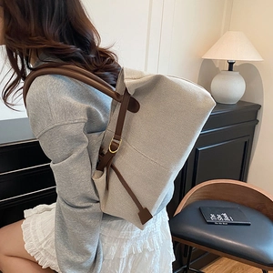 Minimalist beige canvas tote bag with brown leather straps and large capacity