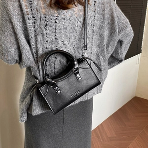 Stylish black PU leather pillow handbag with top handles and adjustable crossbody strap
