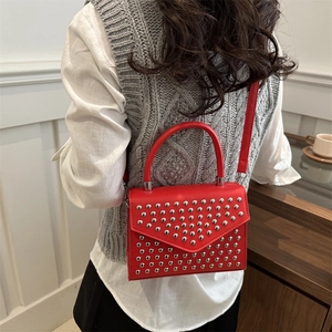 Red matte leather studded handbag with silver rivets and top handle for women