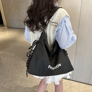 Black nylon shoulder bag with large capacity and woven rope strap for daily commute