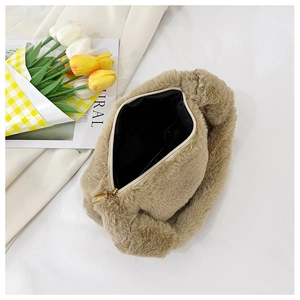 Detail view of khaki faux fur handbag showing smooth zipper and black fabric lining