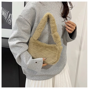 Close-up of khaki faux fur handbag featuring soft plush texture and stylish knotted handle
