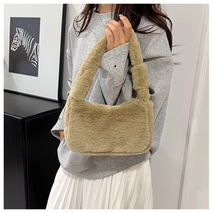 Detailed view of plush faux fur shoulder bag with soft knot handle in warm khaki brown