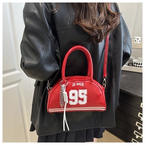 Detail of red glossy PU hobo bag with Los Angeles print and metal chain tassel
