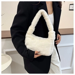 Close-up of fluffy white faux fur shoulder bag worn by model in black suit jacket