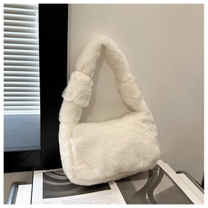 Detailed view of plush faux fur texture on a white winter shoulder bag for women