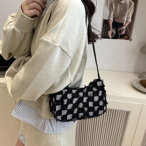 Fashionable denim star patterned crossbody chain bag shown on model in home setting