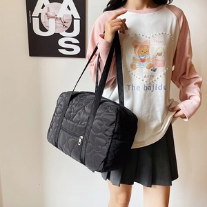 Large black heart-quilted tote bag for moms, featuring high-capacity and shoulder strap