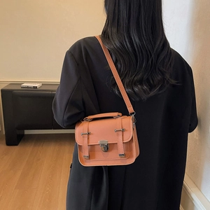 Retro orange matte leather crossbody messenger bag with vintage metal buckle and top handle