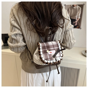Detail of sweet girl backpack with cherry patch, lace trim and star print pattern