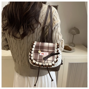 Close-up of the cherry patch, plaid flap and bow details on this sweet style backpack