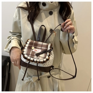 Detail of cute star pattern backpack with brown ruffled lace and bow tie accents