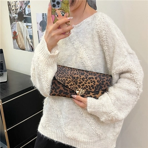 Stylish leopard print envelope clutch bag featuring a gold heart-shaped metal clasp