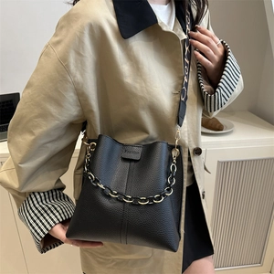 Chic black litchi pattern bucket bag with gold chain and ethnic wide shoulder strap