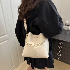 Fashionable beige lychee grain leather bucket bag with plastic chain handle and wide strap