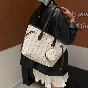 Vintage tote bag with bear print and small round pouch charm shown on a shoulder