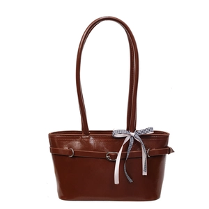 Brown faux leather shoulder tote bag with decorative buckle and checkered bow ribbon