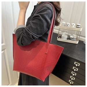 Detail of red crocodile texture large tote bag with elegant embossed leather finish