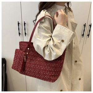 Red tweed tote bag with matching zip pouch and leather straps shown on a model