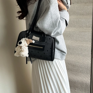 Chic black polka dot backpack for women with a cute white puppy plush keychain