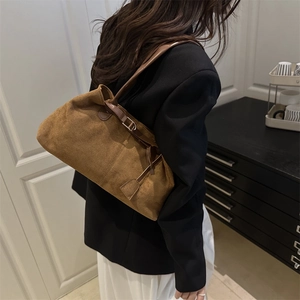 Brown frosted suede tote bag for women shown from a stylish side view in a warm room
