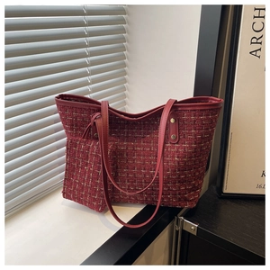 Detail of red tweed tote bag set with golden metallic threads and small coin purse