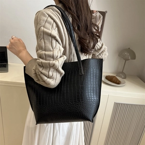 Classic black crocodile pattern PU leather tote bag worn by a model in a modern office setting
